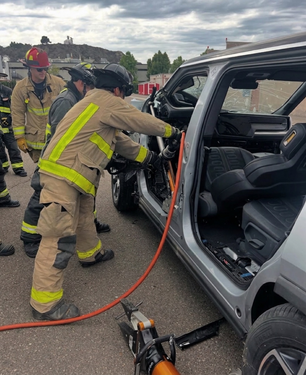 Firefighters cutting into an electric SUV during a live extrication